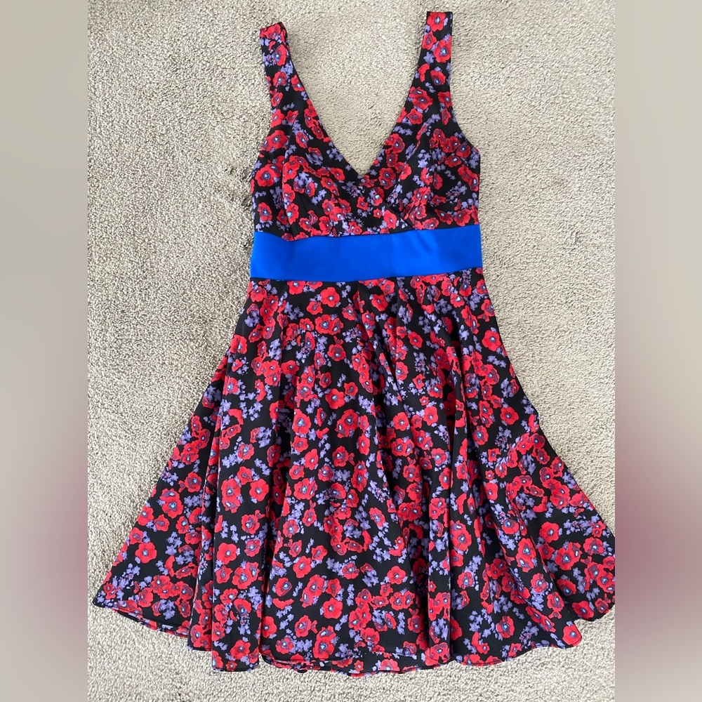 Fun & flirty cocktail dress with adjustable straps & accent tie back!